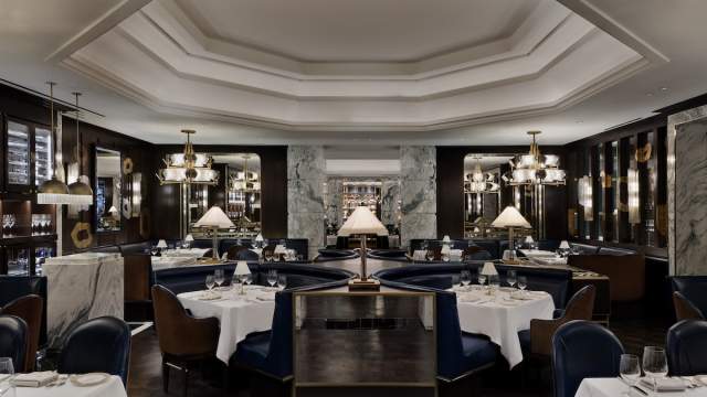 The upscale interior of Don's Prime Steakhouse featuring elegant booth seating and warm lighting.