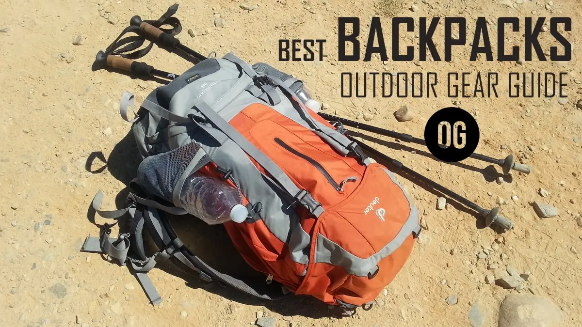 A traveler carrying a large hiking rucksack while walking in a rugged outdoor landscape.