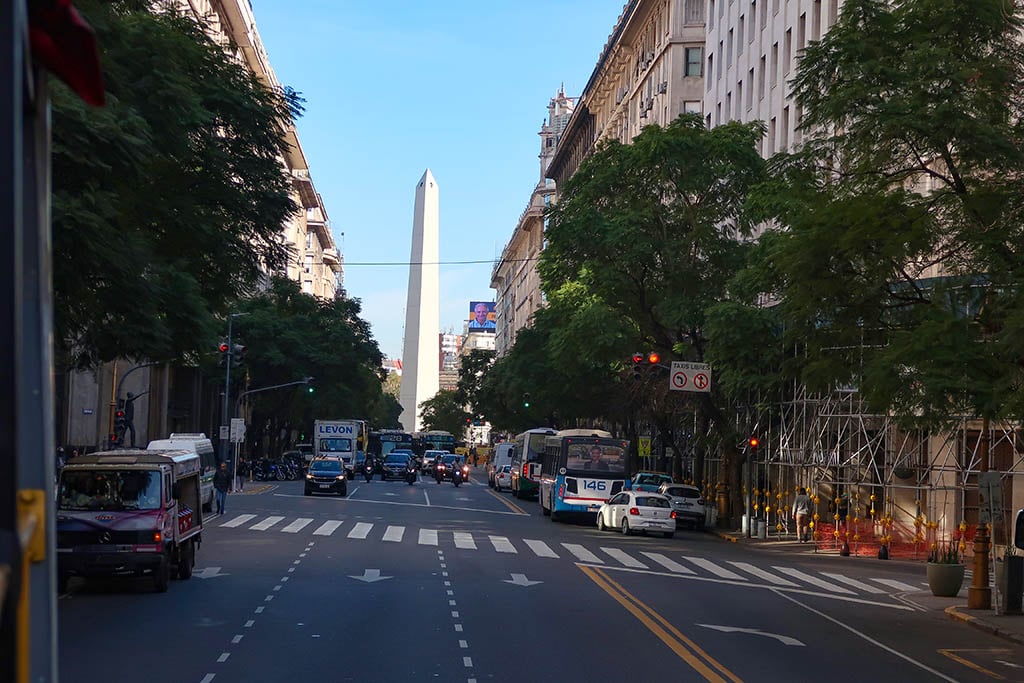 The towering white Obelisk monument standing in the center of the wide Avenida 9 de Julio.