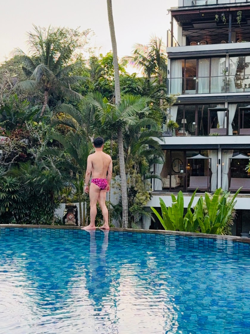 An infinity pool overlooking lush green rice terraces in Ubud.