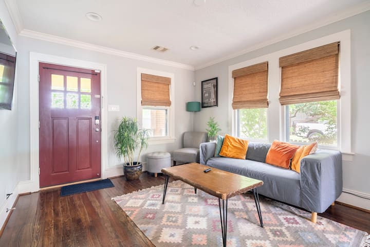 Exterior of a cozy and modern blue two-bedroom bungalow in the Houston Heights area.