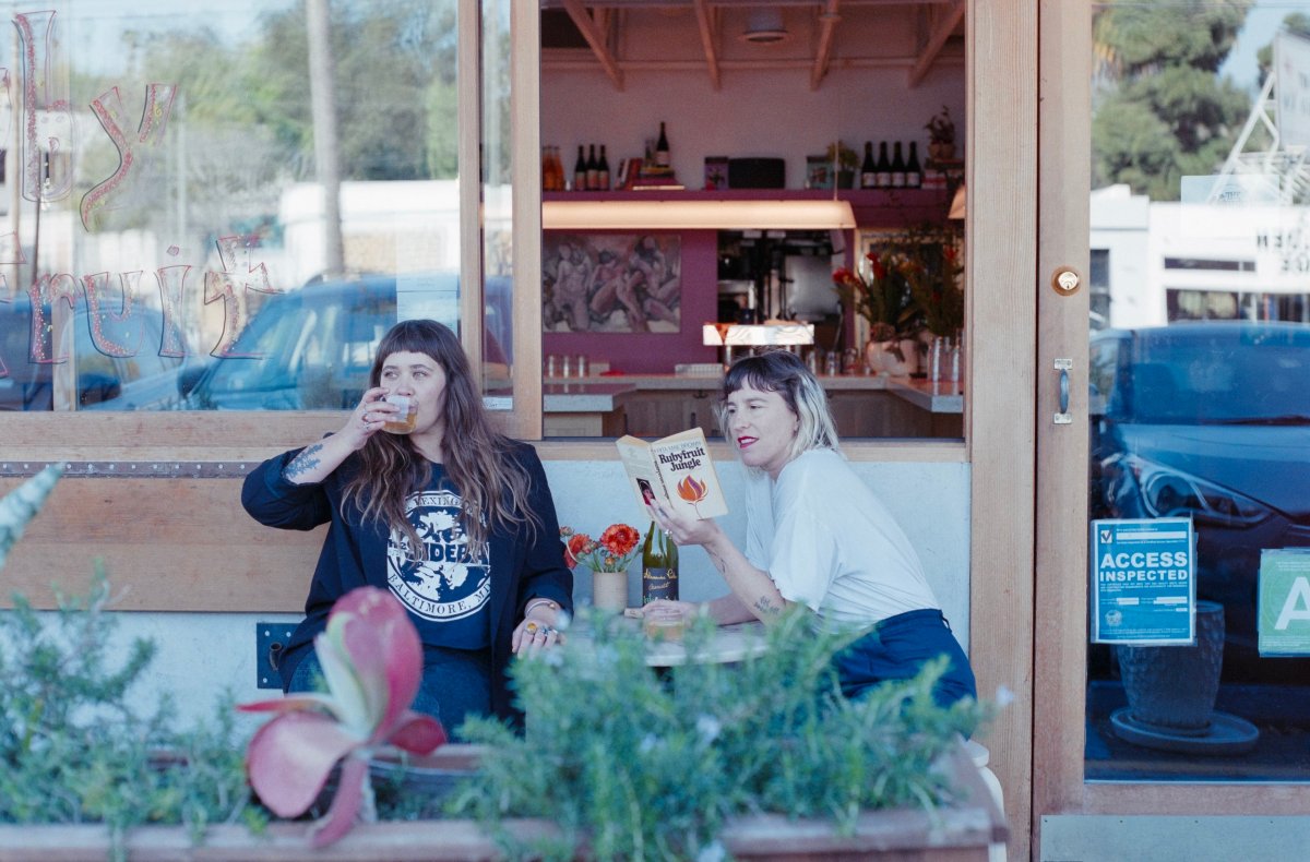 Emily Bielagus and Mara Herbkersman standing together outside the bar entrance.