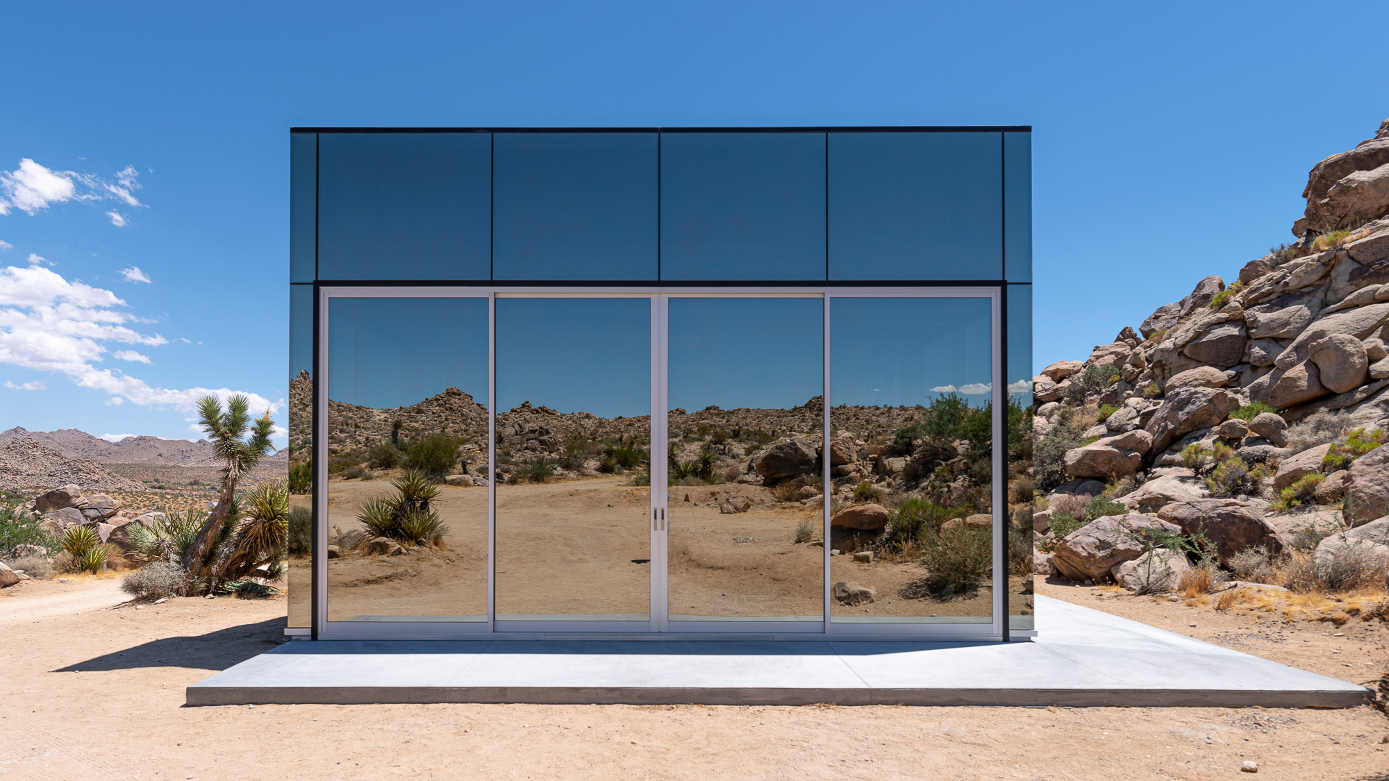 Invisible House exterior amidst desert rock formations