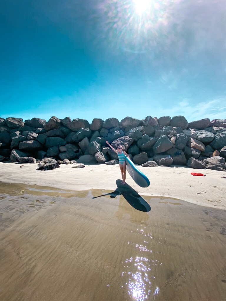 A surfer catching a wave in the blue waters of Oceanside.