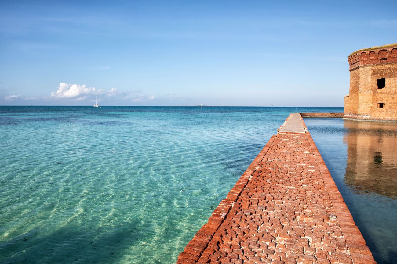 A long view of the brick moat wall encircling the massive hexagonal Fort Jefferson structure.