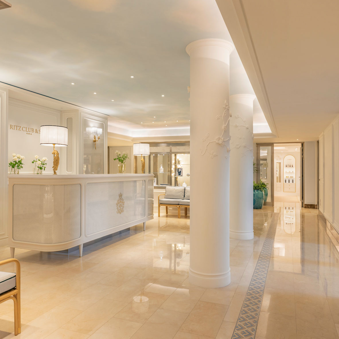 The blue-tiled swimming pool at Ritz Club & Spa with neoclassical architecture.