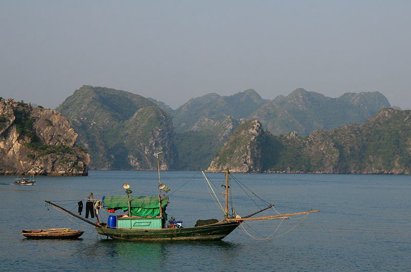 Aerial view of emerald waters and steep limestone karsts in Halong Bay, Vietnam.
