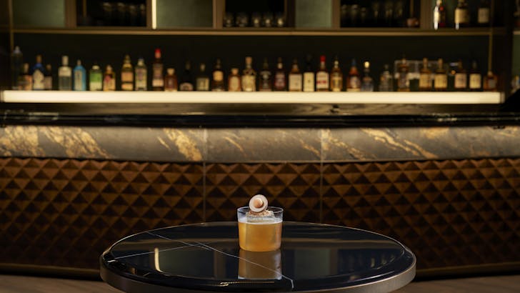 A specialty cocktail inspired by Peranakan heritage with unique garnishes