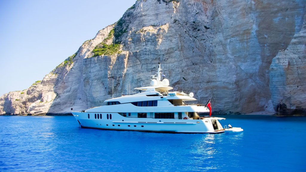 A private luxury yacht anchored in a calm bay for an island-hopping excursion.