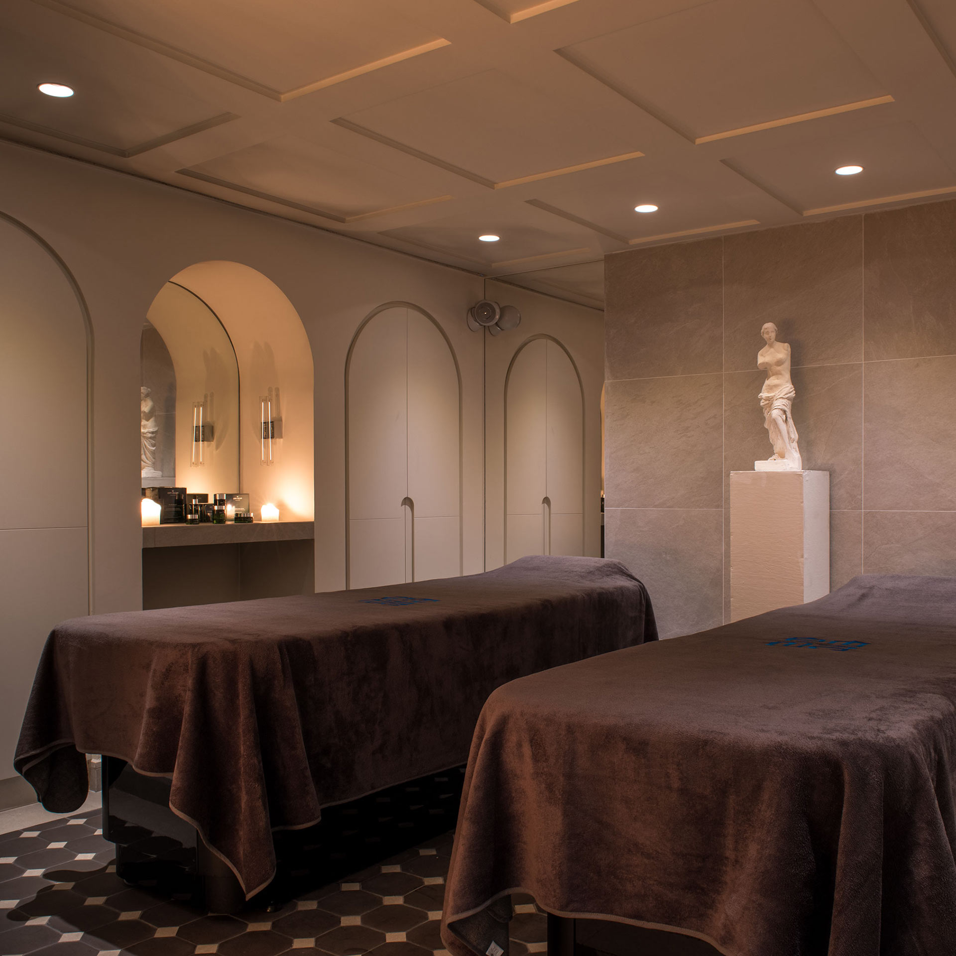 The artistic and dim-lit swimming pool at Sinner Paris with dramatic shadows.