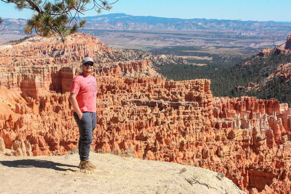 A wooden observation platform overlooking the red rock amphitheater of Bryce Canyon.
