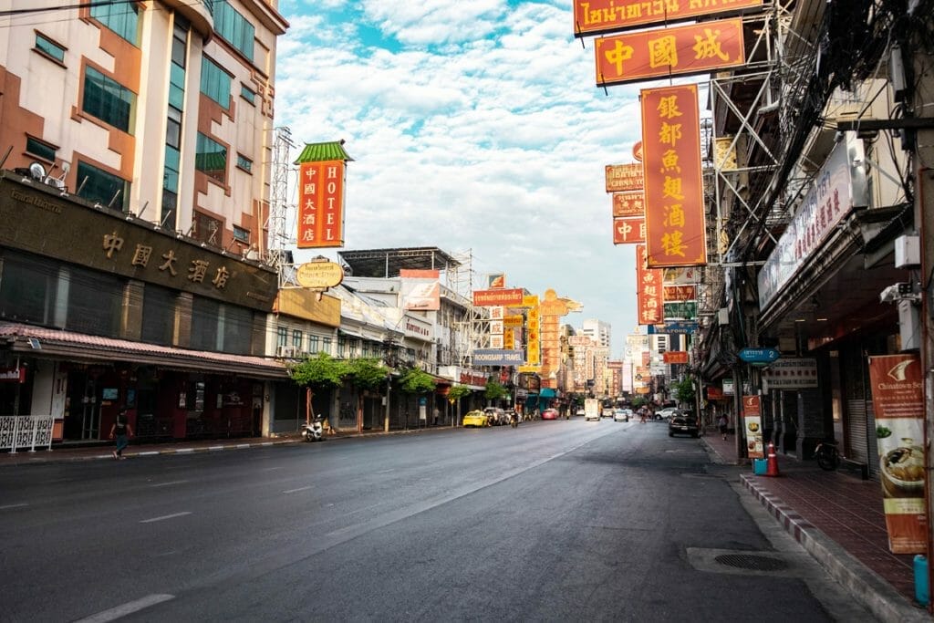A quiet morning scene on Yaowarat Road with few people and soft morning light.