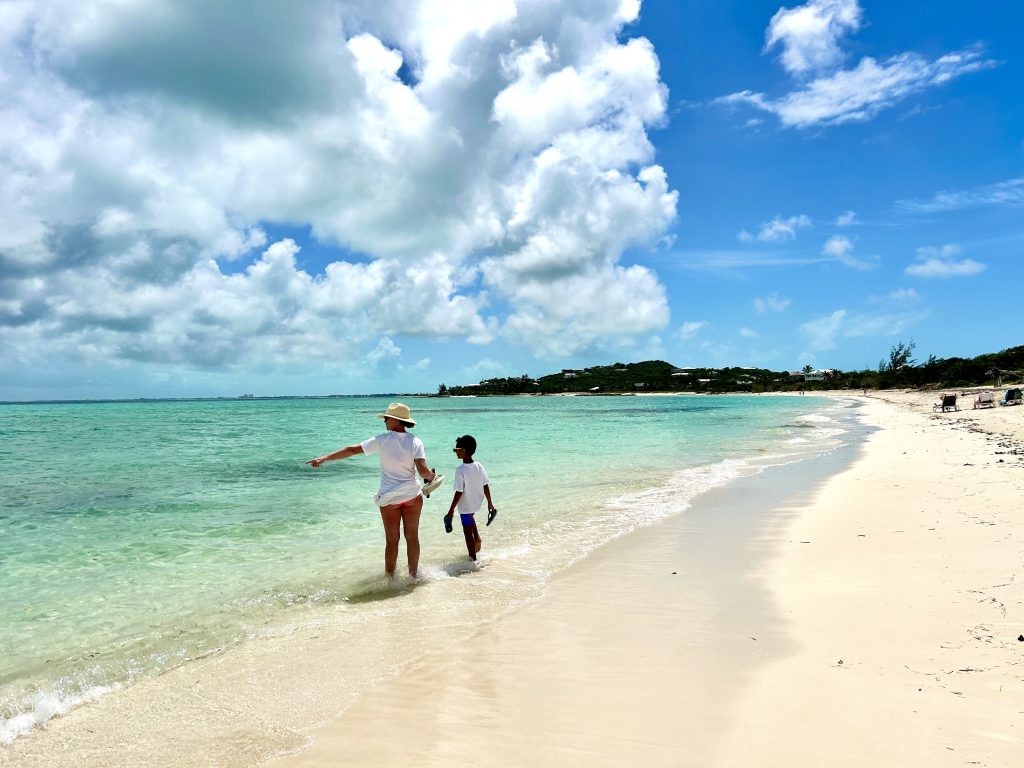 Expansive view of crystal clear, shallow turquoise water under a bright sun.