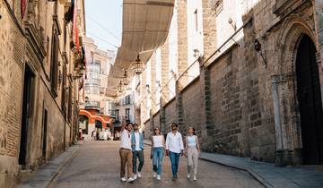 Wide shot of the ancient Roman Aqueduct of Segovia under a clear sky.