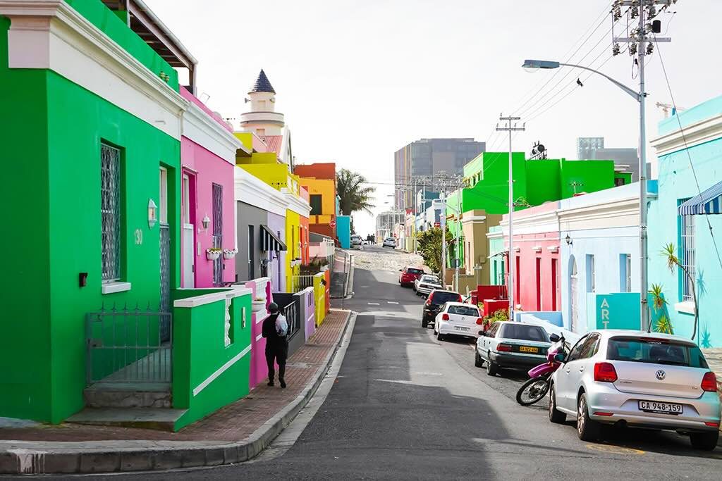 A row of brightly colored historic houses in the Bo-Kaap neighborhood of Cape Town.