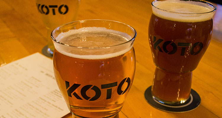 Elevated view of a blue lake at the bottom of a deep rocky canyon.