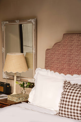 A variety of textured bed accessories including throws and decorative cushions layered on a bed.