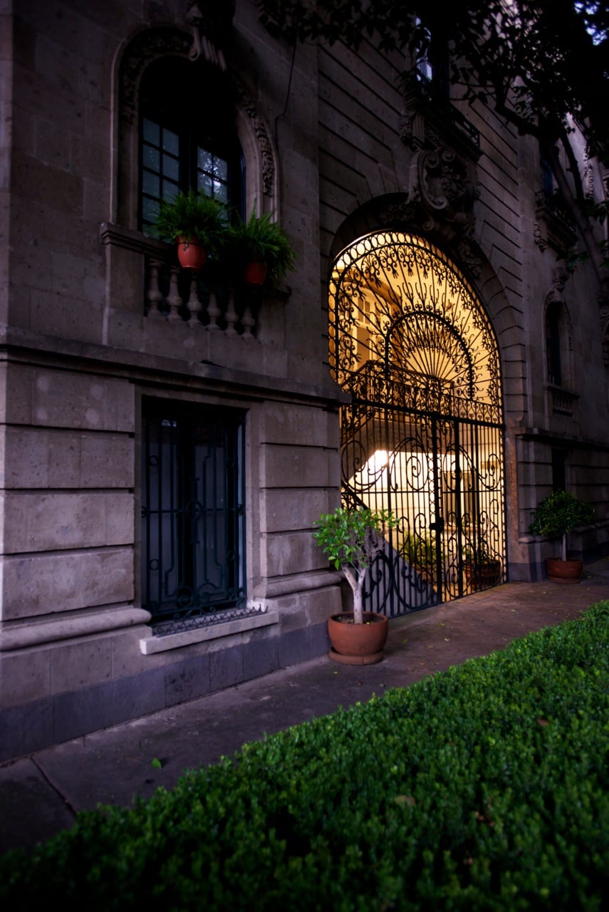 Wrought iron gates at the entrance of a historic Porfirian townhouse.