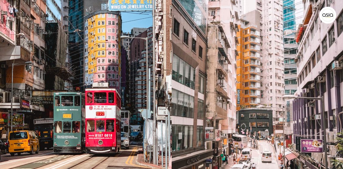A red and white iconic double-decker tram driving through the streets of Hong Kong Island.