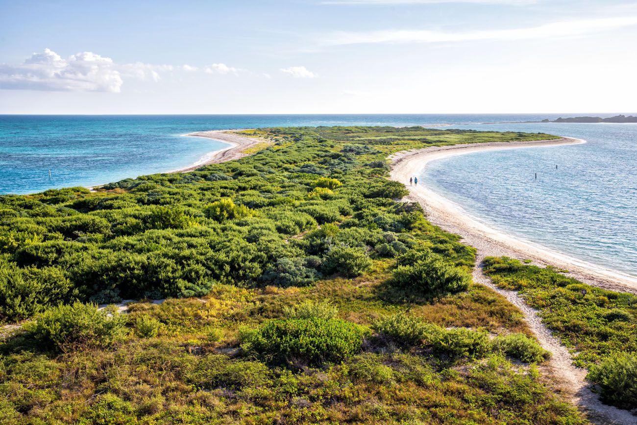 A scenic view of the sandy shoreline and vegetation of Bush Key, connected to Garden Key by a narrow land bridge.