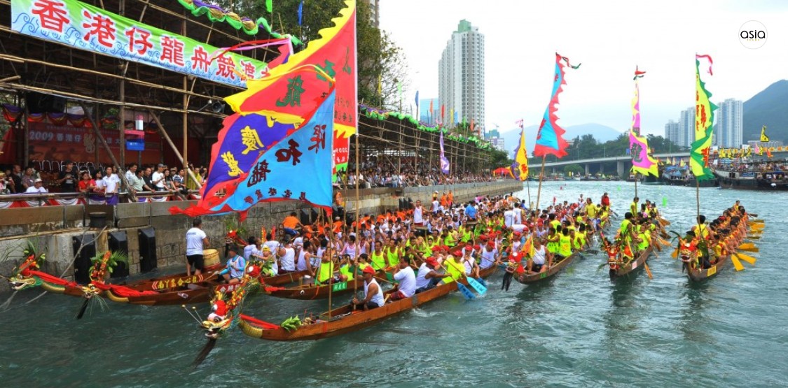A vibrant traditional Chinese dragon dance performance during a local festival in Hong Kong.