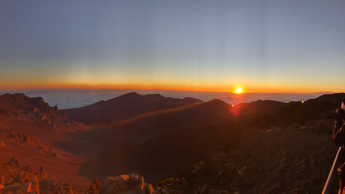 The sun rising above a thick layer of clouds at the summit of Haleakala National Park.