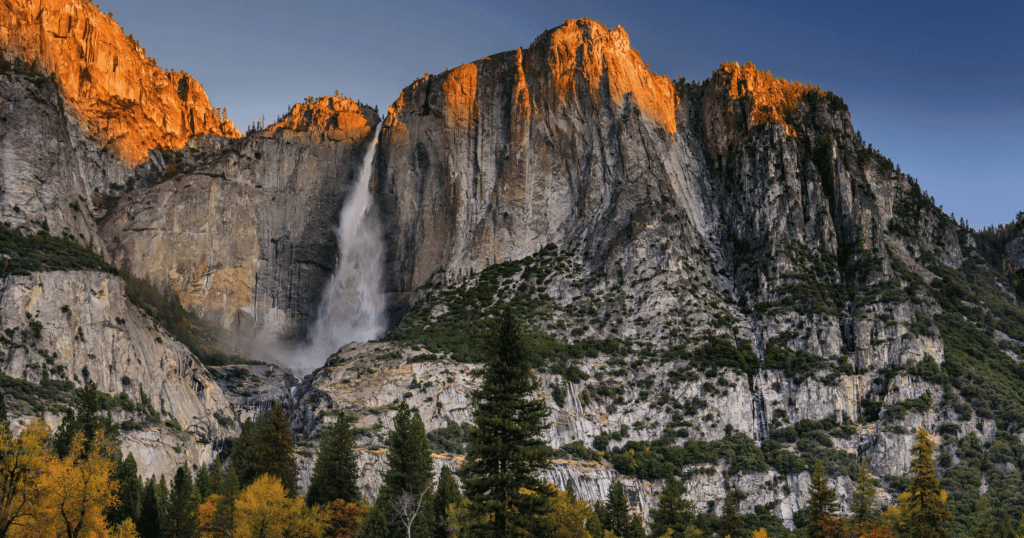 Majestic alpine mountains and pine forest representing the scenic beauty of the U.S. National Parks.
