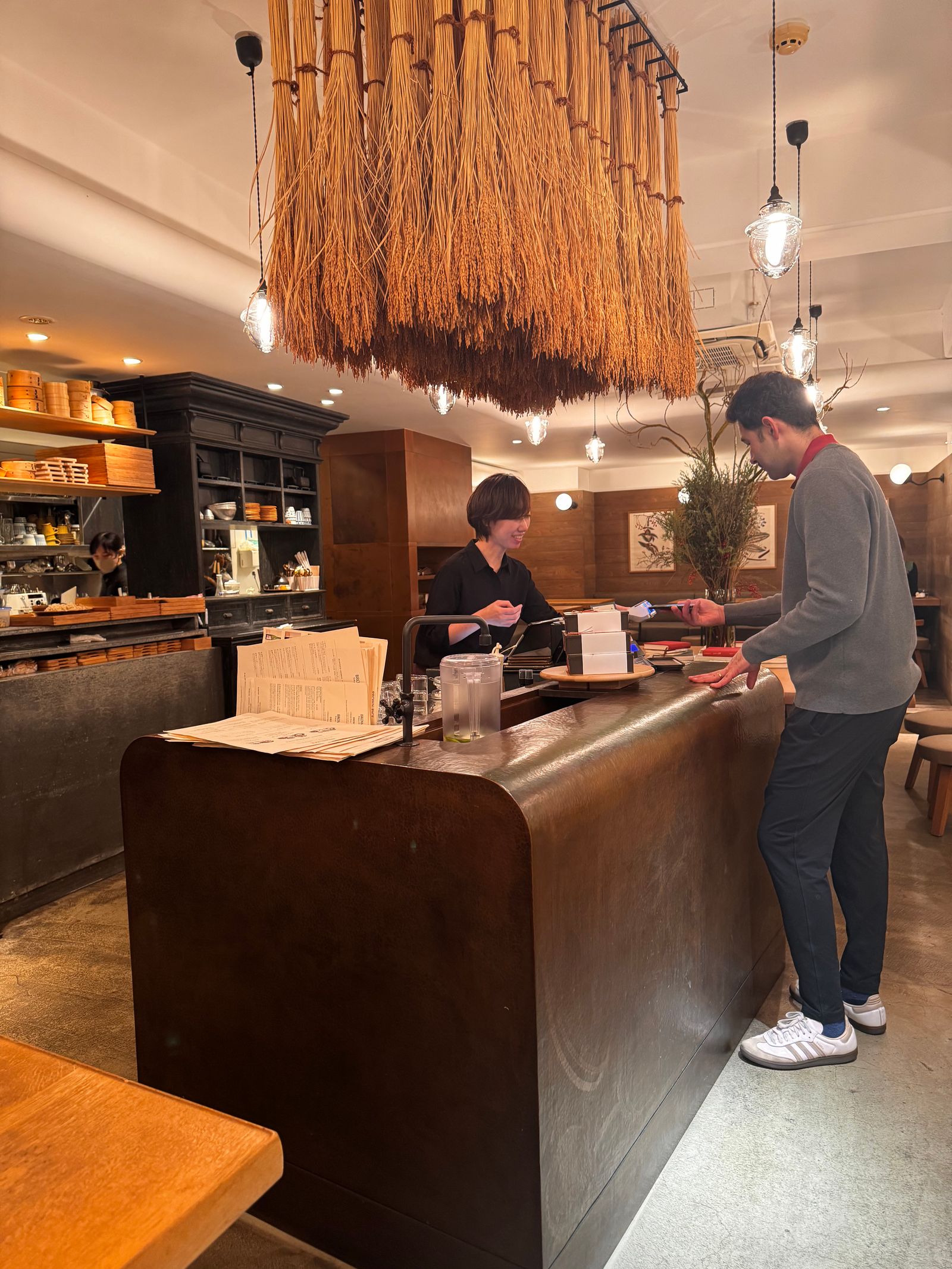 An indoor market or department store basement filled with various food stalls and shoppers.