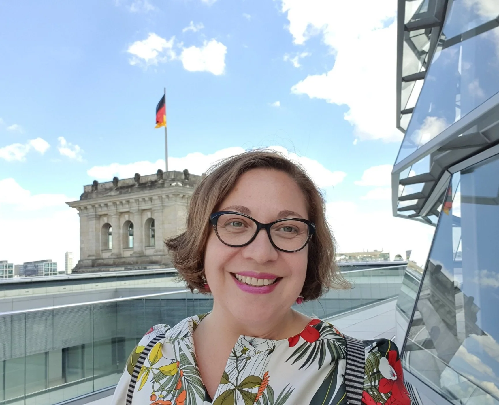 The glass and steel dome of the Reichstag building in Berlin with people walking on the spiral ramp.