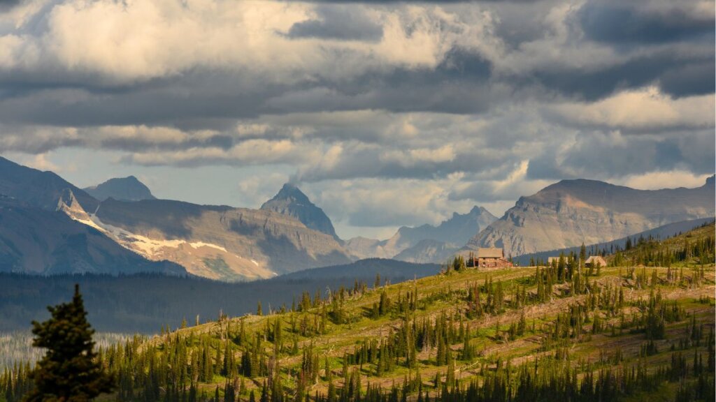 The stone Granite Park Chalet sitting on a ridge in the Rocky Mountains.