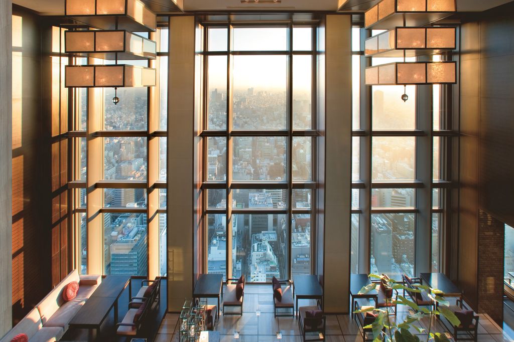 Luxury hotel room at Mandarin Oriental Tokyo with floor-to-ceiling windows overlooking the financial district.
