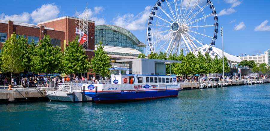 A Chicago water taxi docked at Navy Pier during the day.