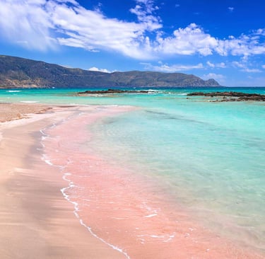 Close-up shot of shimmering, transparent turquoise sea water over white sand.