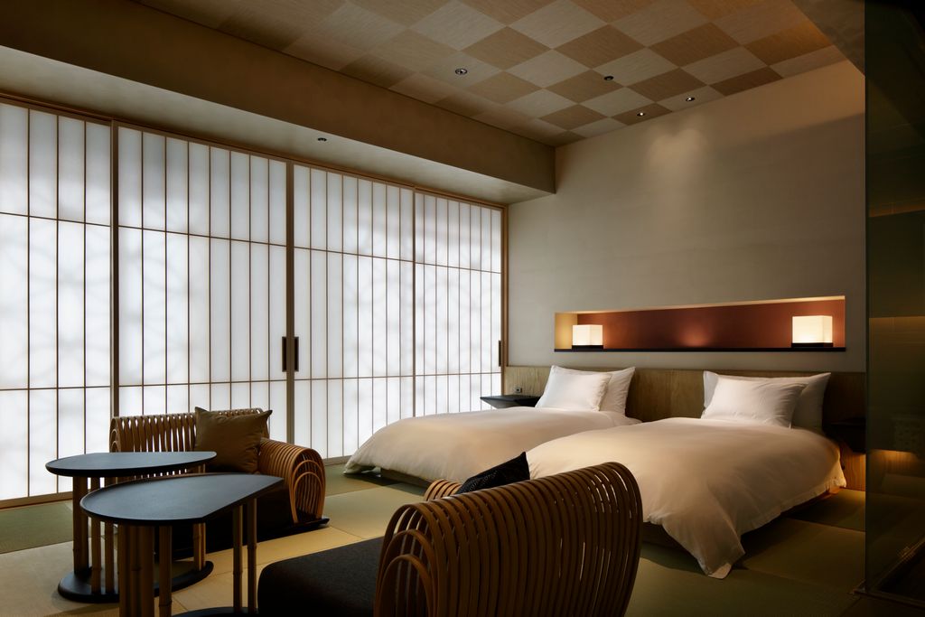 Minimalist luxury bedroom at Hoshinoya Tokyo featuring tatami mats and washi paper screens.
