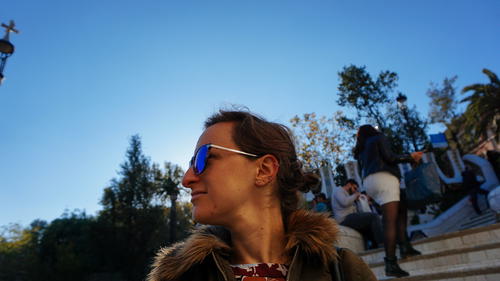 A view down a historic European street with ornate balconies and architectural details.