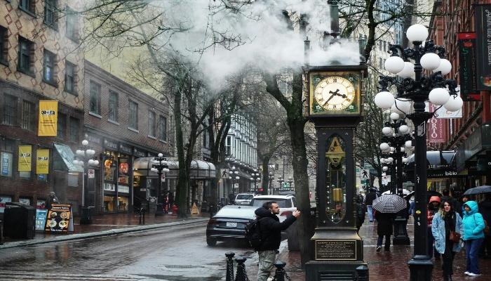 A historic cobblestone street in Vancouver's Gastown district featuring Victorian-style architecture.