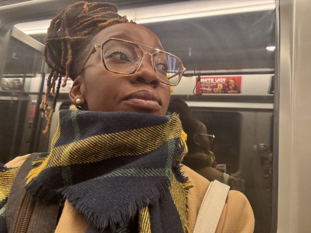 A traveler riding the London Underground tube during a solo journey.