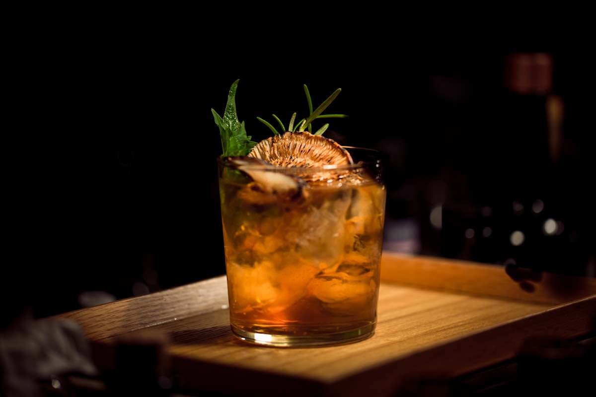 A hand-crafted cocktail with garnish served on a bar top at a modern Latin restaurant.