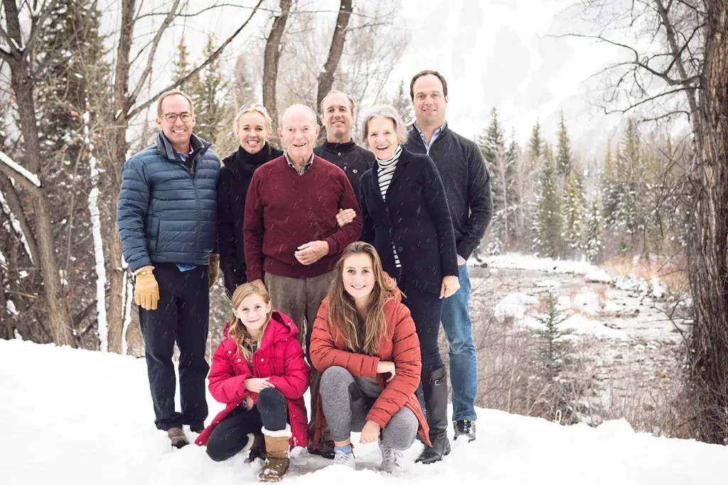 A multi-generational family laughing during a professional photoshoot at a luxury tropical resort.