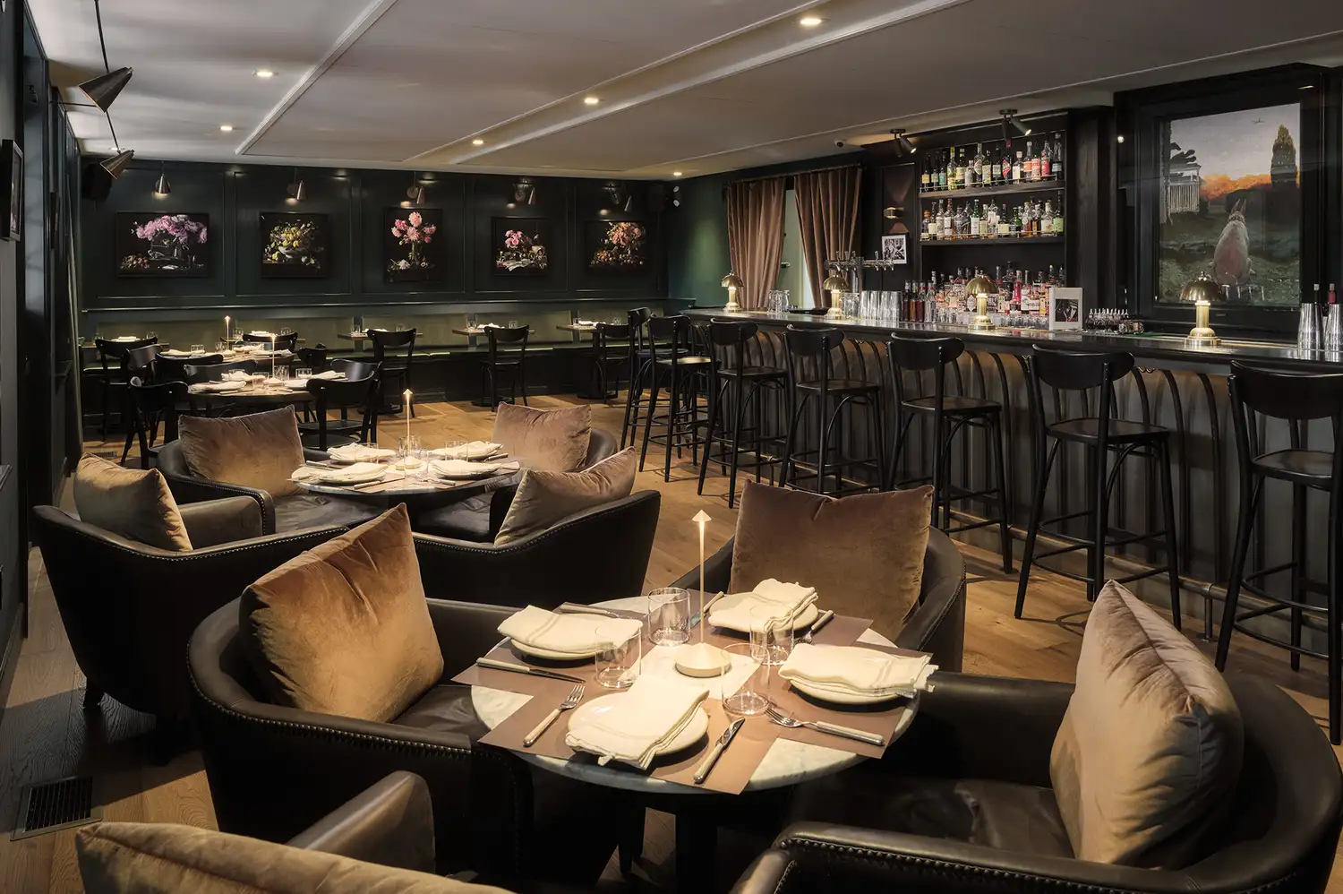 The elegant interior of the Dog & Deer Tavern with a bar and cozy seating areas.