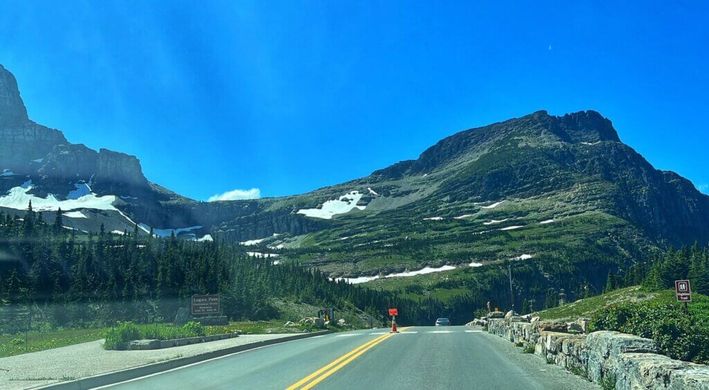 Logan Pass visitor center nestled at the base of towering peaks in Glacier National Park.