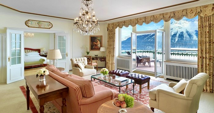 A luxurious and spacious suite interior featuring elegant wood paneling and plush furnishings.