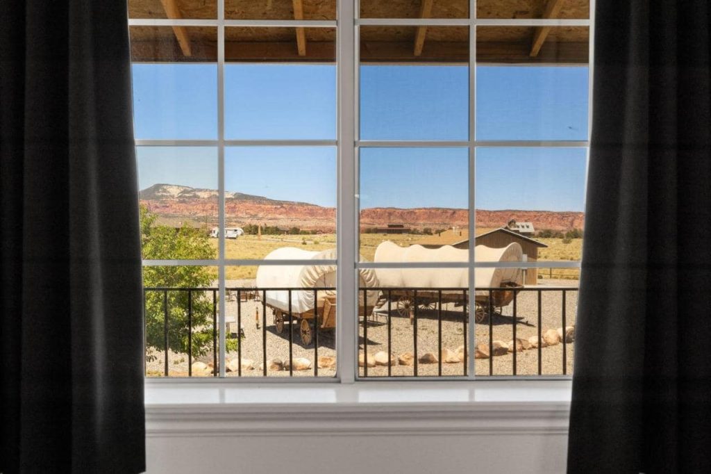 A luxury Conestoga wagon at Broken Spur Inn, featuring traditional wooden wheels and a canvas cover.