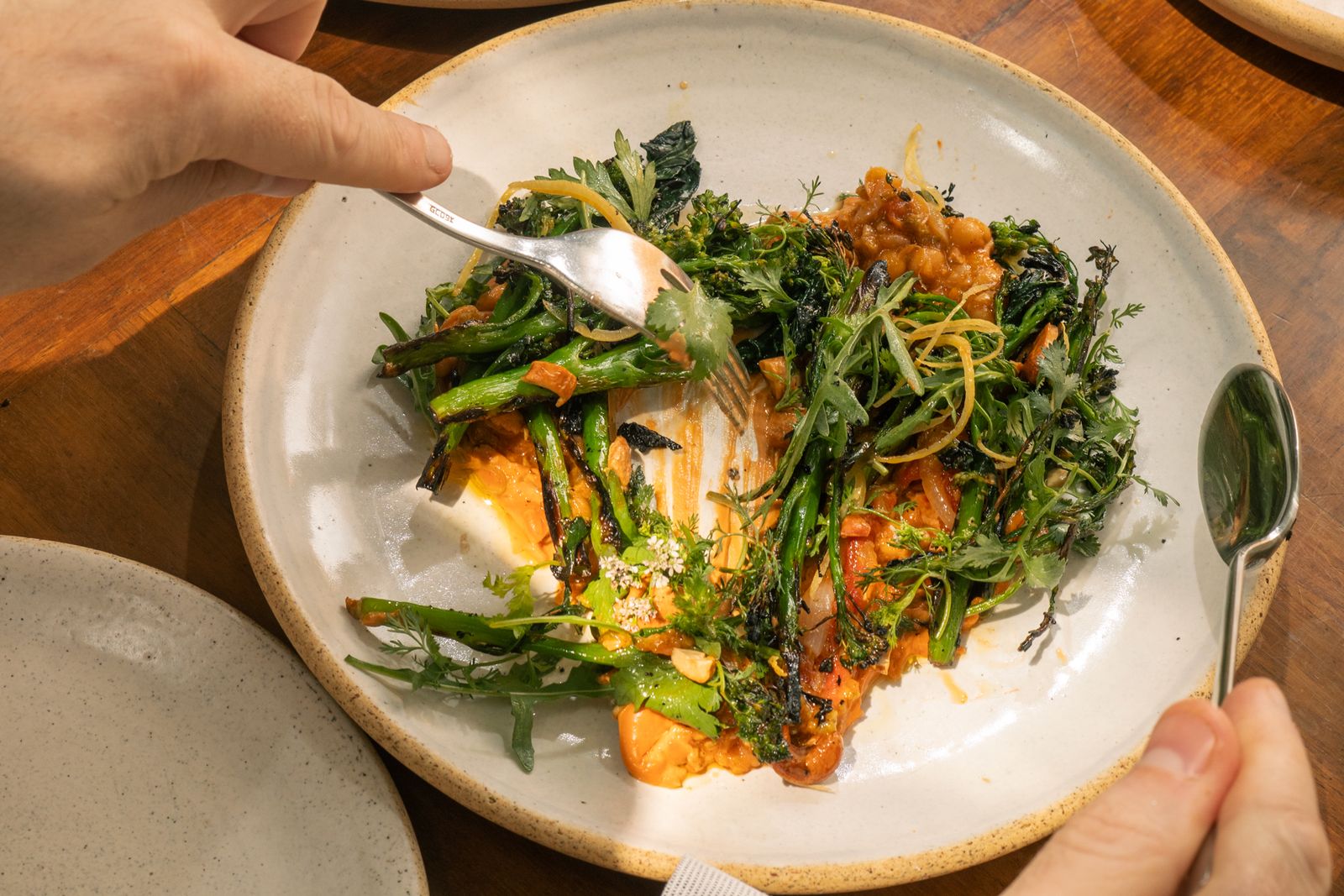 A minimalist gourmet dish served on a white plate at Meroma restaurant.
