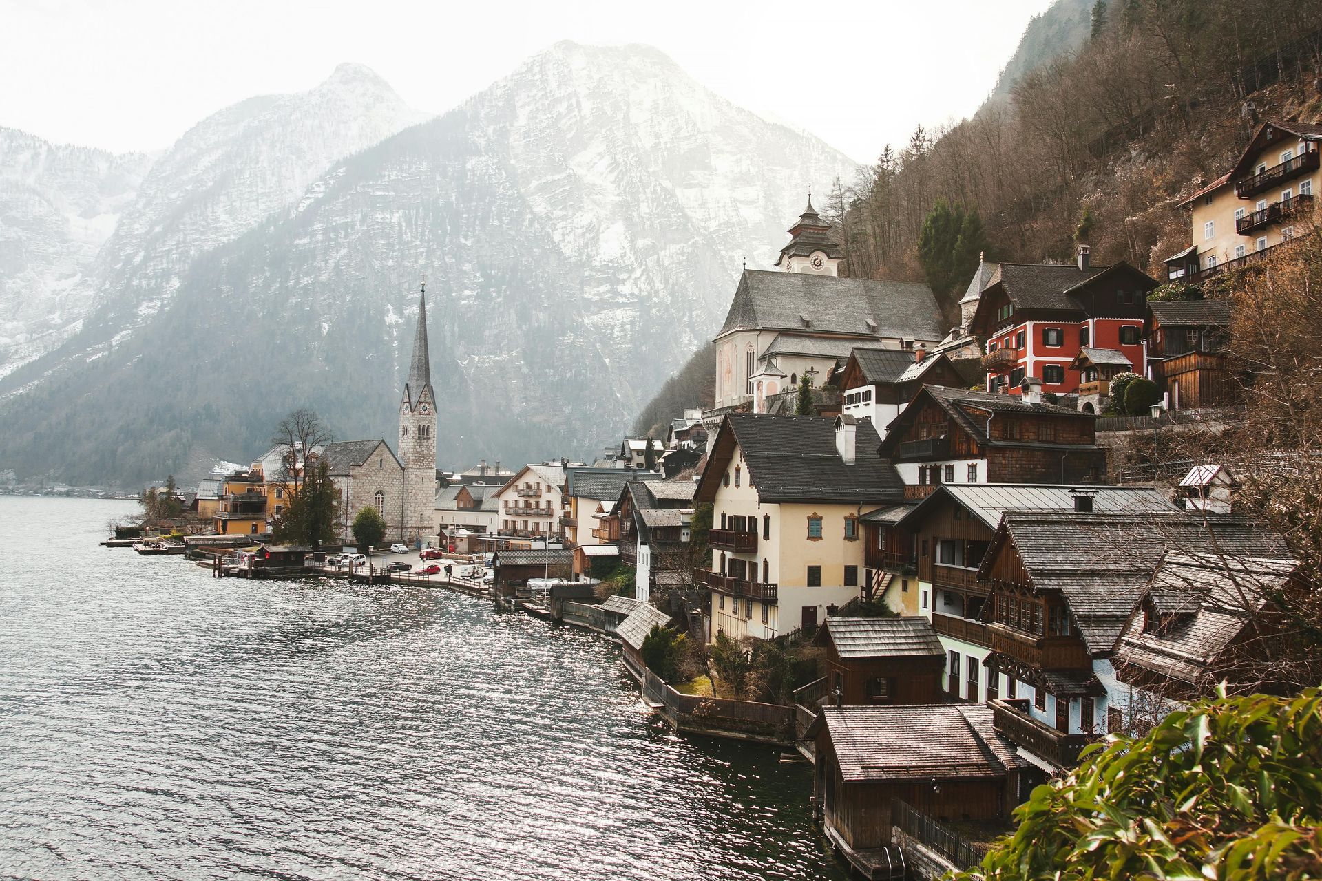 A quiet, narrow cobblestone street lined with historic stone buildings in a European village.