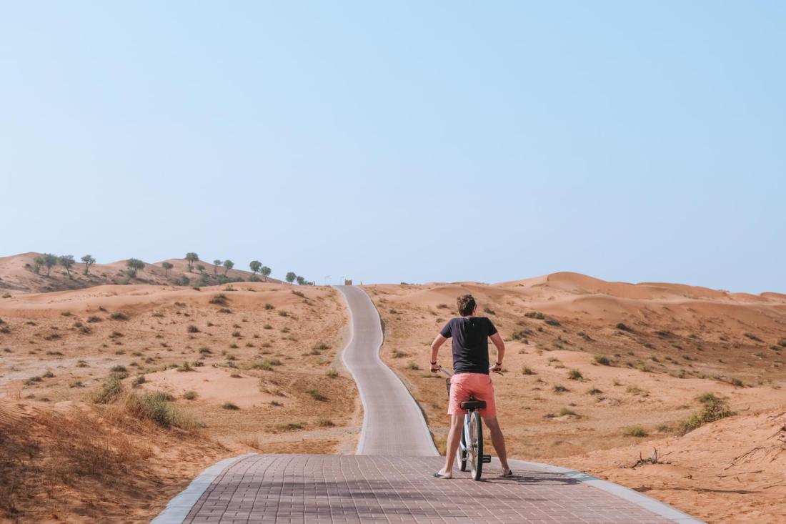 View from a private resort terrace overlooking a vast desert valley in Ras Al Khaimah.