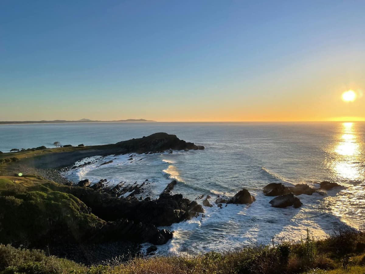 Wide aerial perspective of the turquoise Crescent Head coastline and headlands.