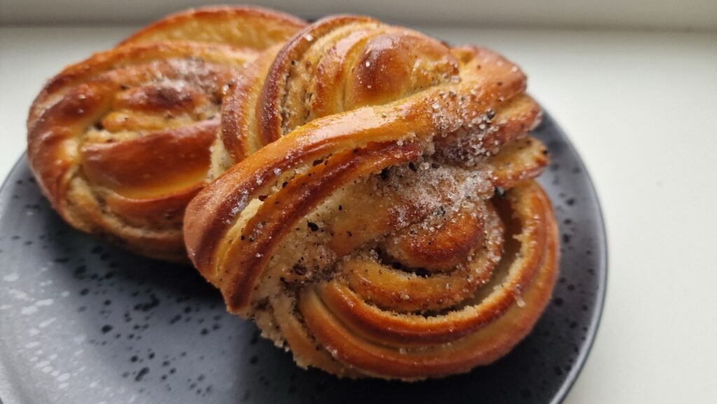 Assorted handmade cardamom buns on display at Andersen Bakery.