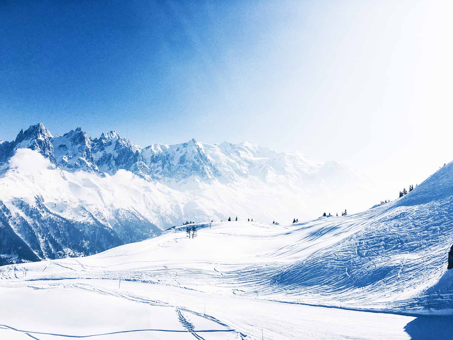 Snow-covered ski slopes and majestic mountain peaks in Chamonix.